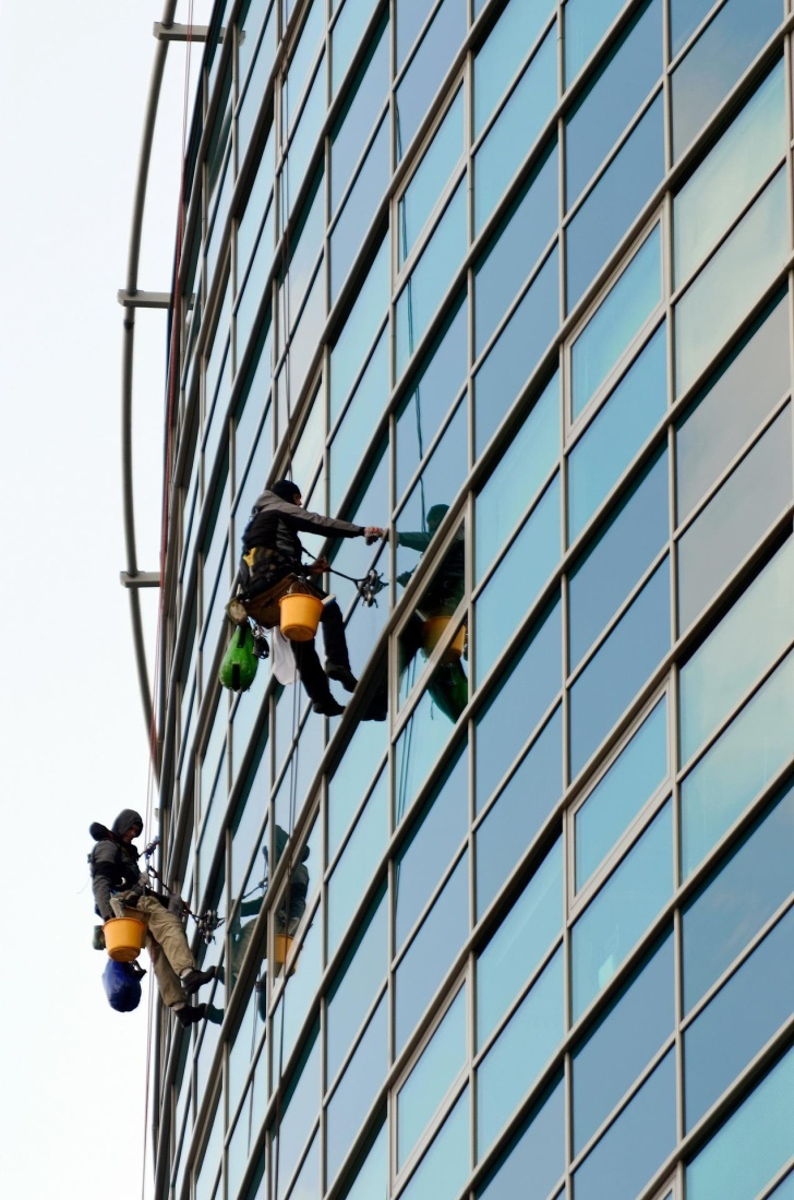 Experts cleaning the windows of a building in Modesto, CA