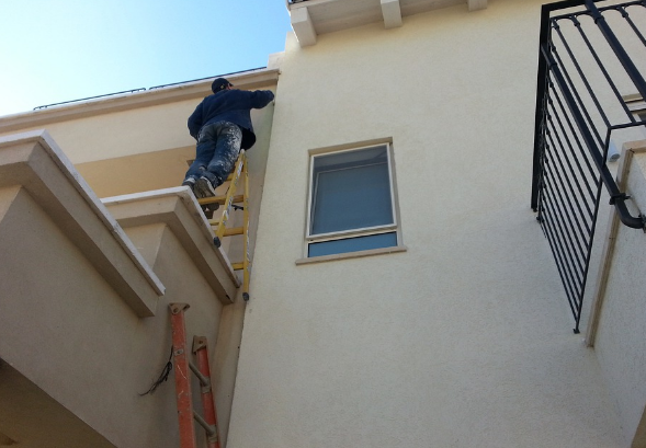 An expert cleaning roof moss in Modesto, California