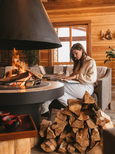  A woman reading around her fireplace