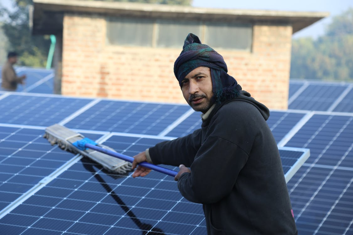  A man cleaning the solar panels